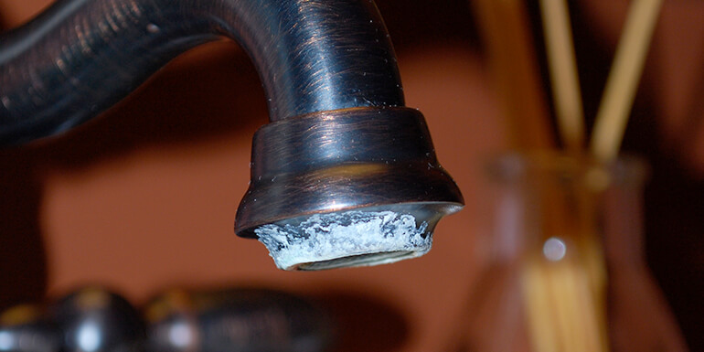 dark-faucet-with-calcium-buildup-around-opening