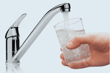 hand holding glass under running faucet