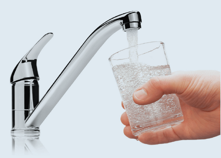 hand holding glass under running faucet