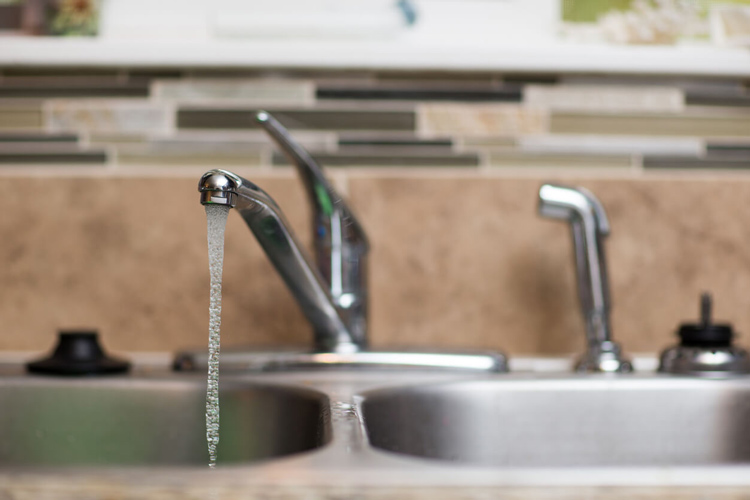 kitchen-sink-with-stainless-steel-faucet-and-running-water