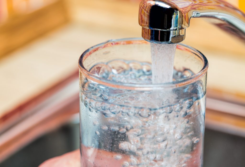 closeup-shot-of-a-glass-of-water-from-a-kitchen-faucet-after-flooding