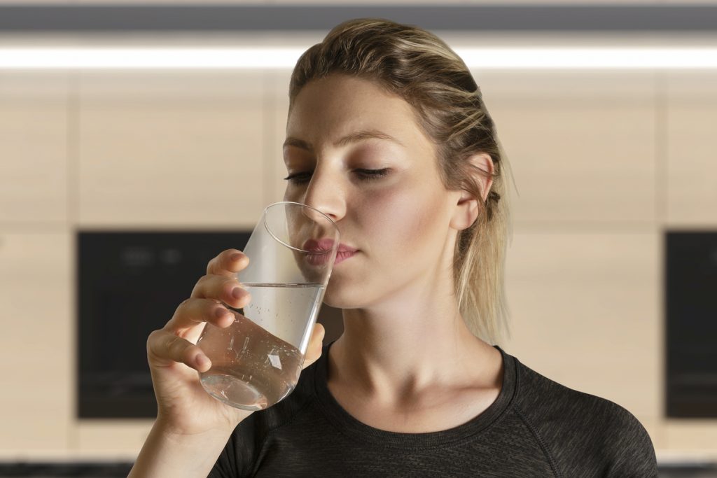 woman-holding-a-glass-of-water-smelly-water-concept
