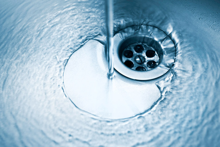 water-stains-concept-kitchen-sink-with-running-water